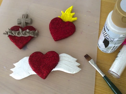 Make air dry clay sacred heart magnets.